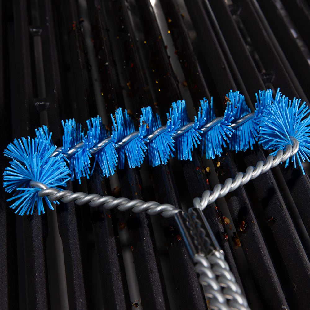 Extra-wide grill brush with blue nylon bristles on metal grill grates