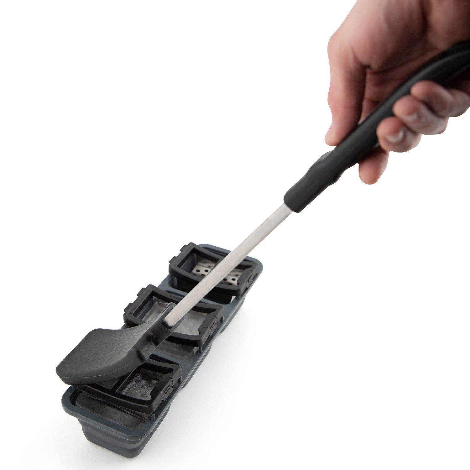 Ice grill brush held in hand, showing long handle and gray multi-slot scraper head