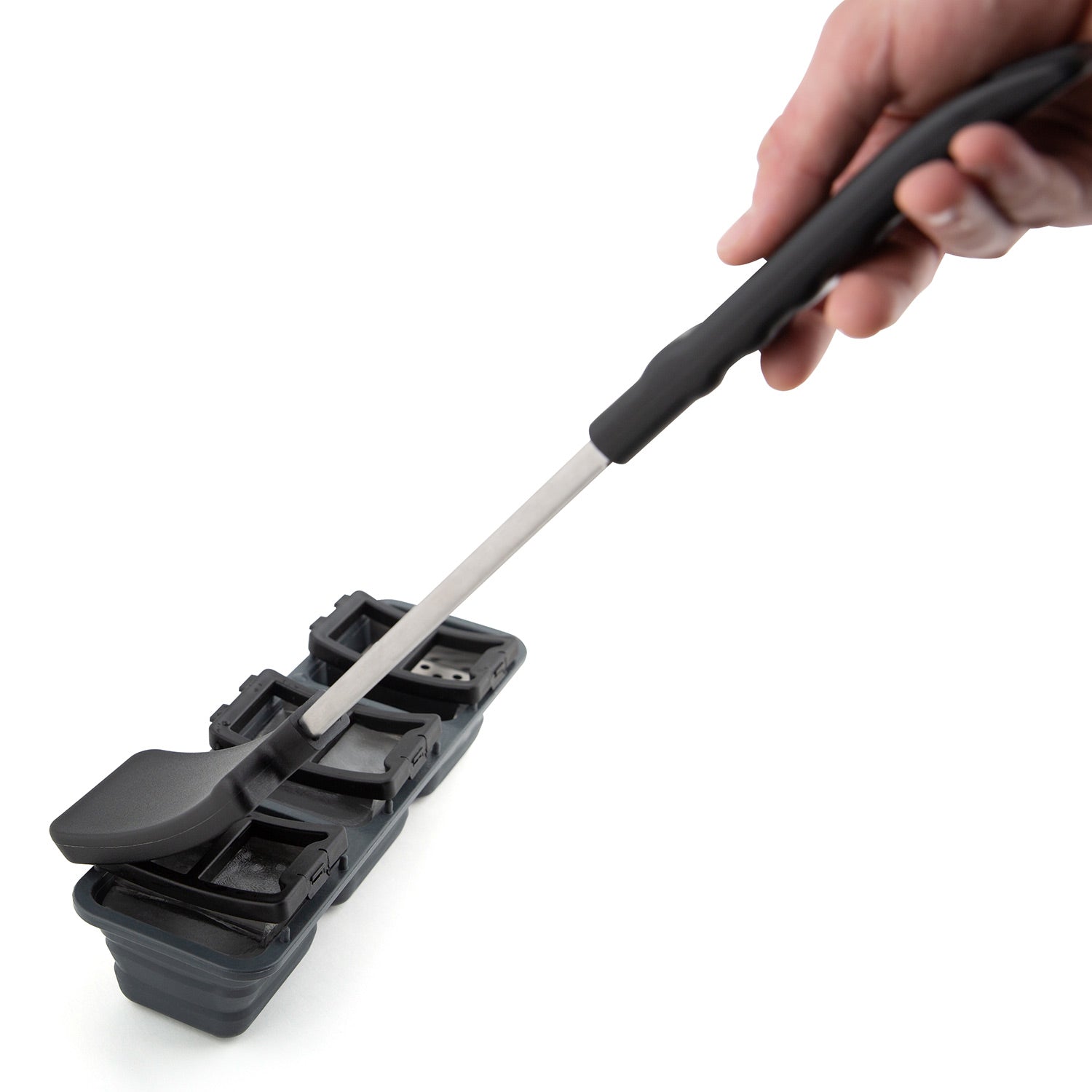 Ice grill brush held in hand, showing black handle and gray scraper head