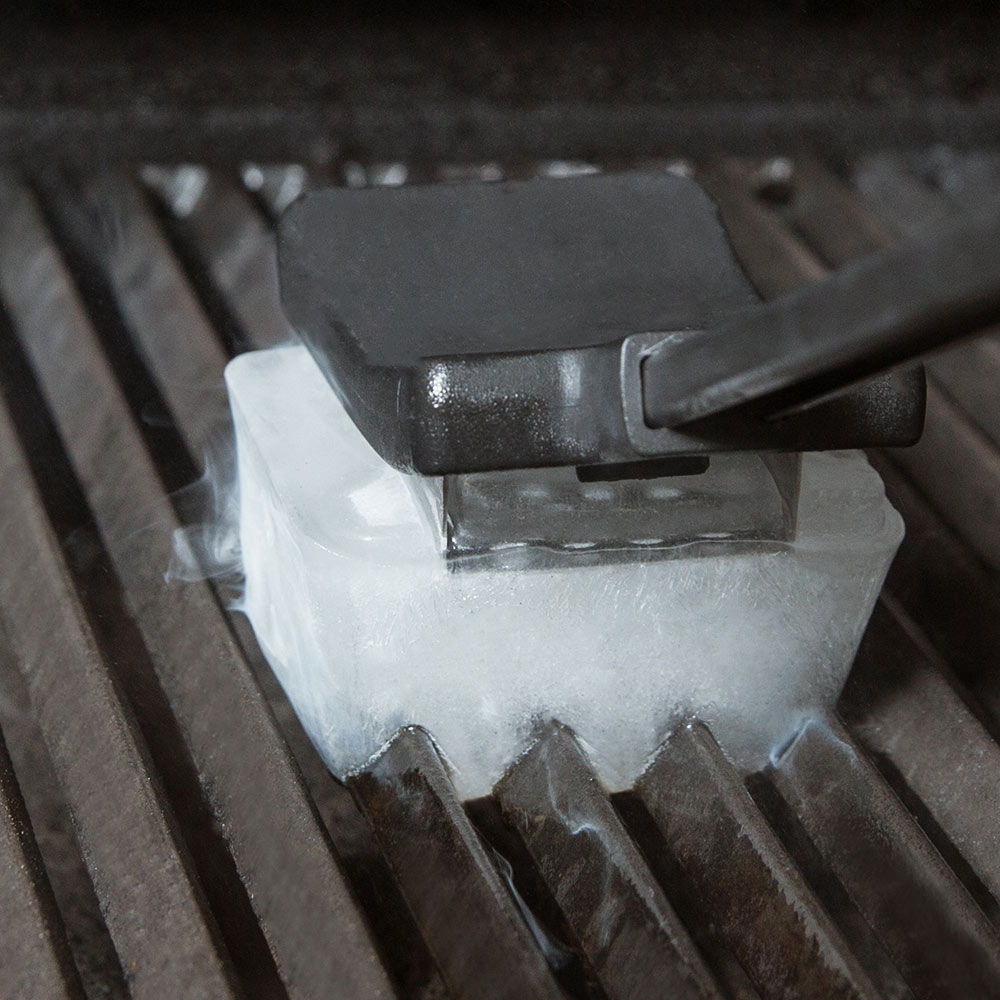Ice grill brush scraper head on grill grates with frosty buildup
