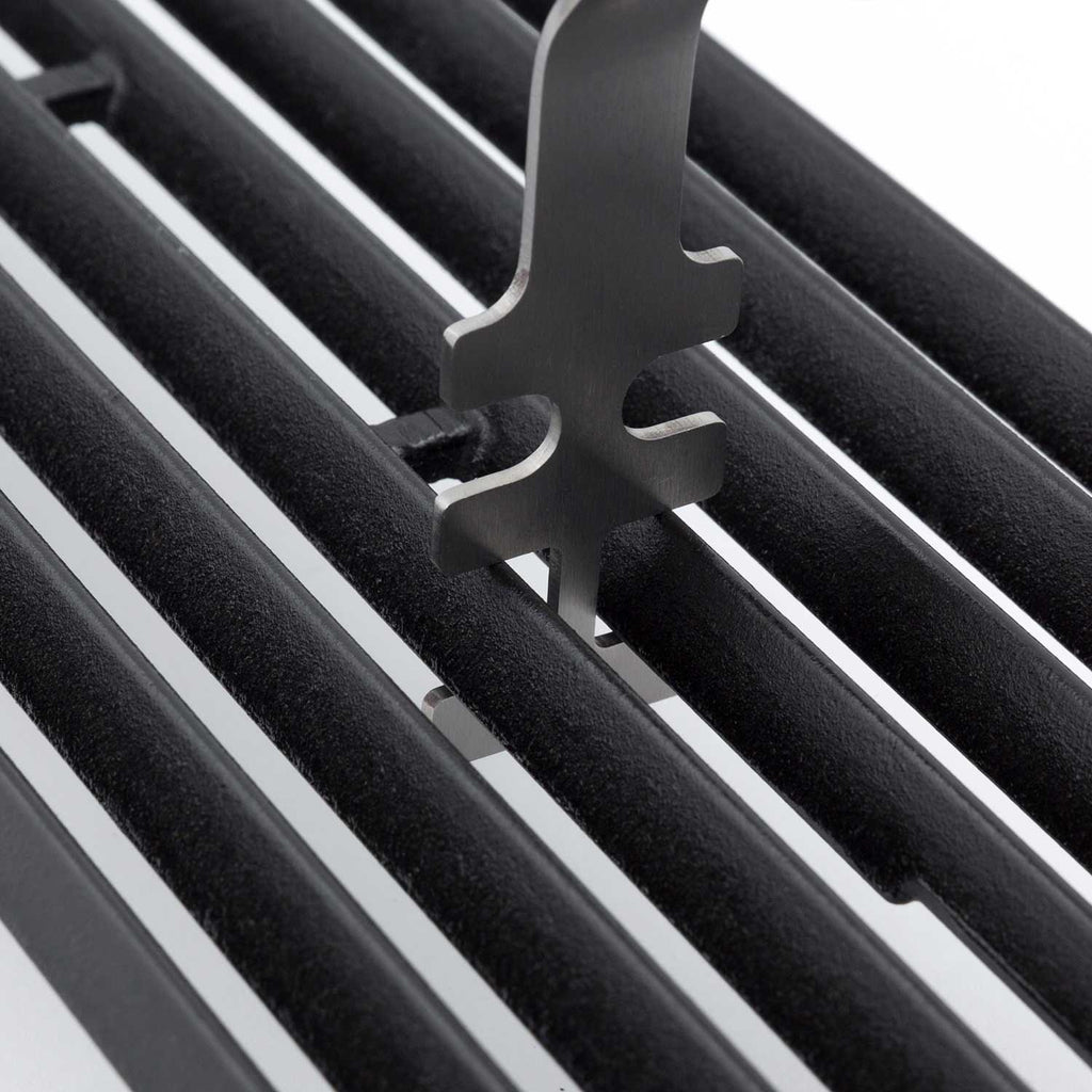 Broil King grid lifter close-up with metal prongs on black grill grates