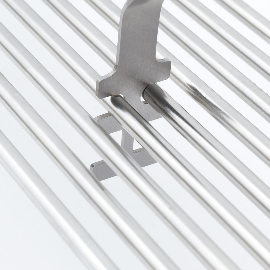 Broil King grid lifter close-up with metal prongs on silver grill grates