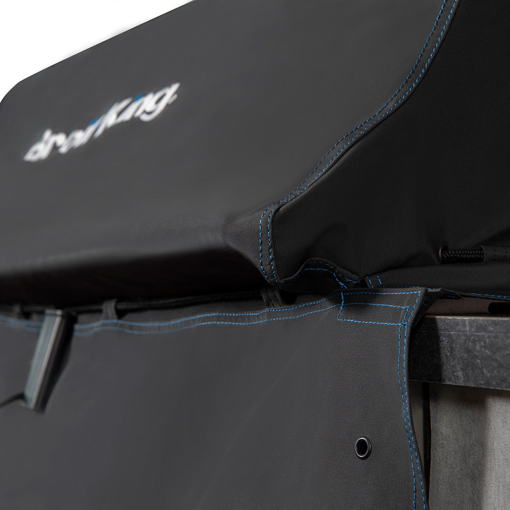 Black grill cover hood corner with blue-trim piping and stitched seams
