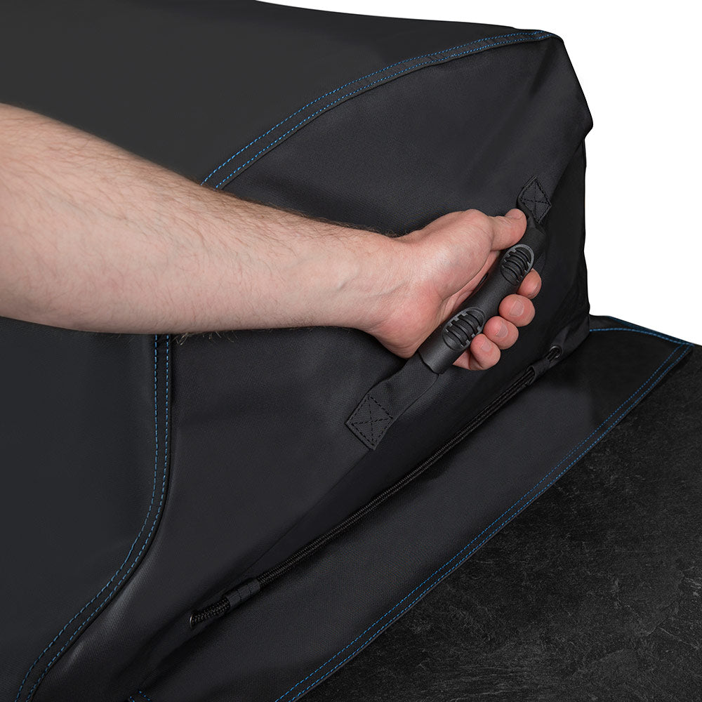 Black grill cover front edge being pulled tight with strap and snap closure