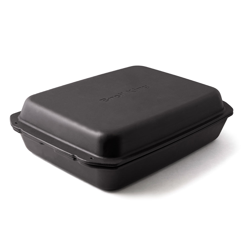 Broil King cast iron multi roaster with closed lid, dark rectangular roaster pan