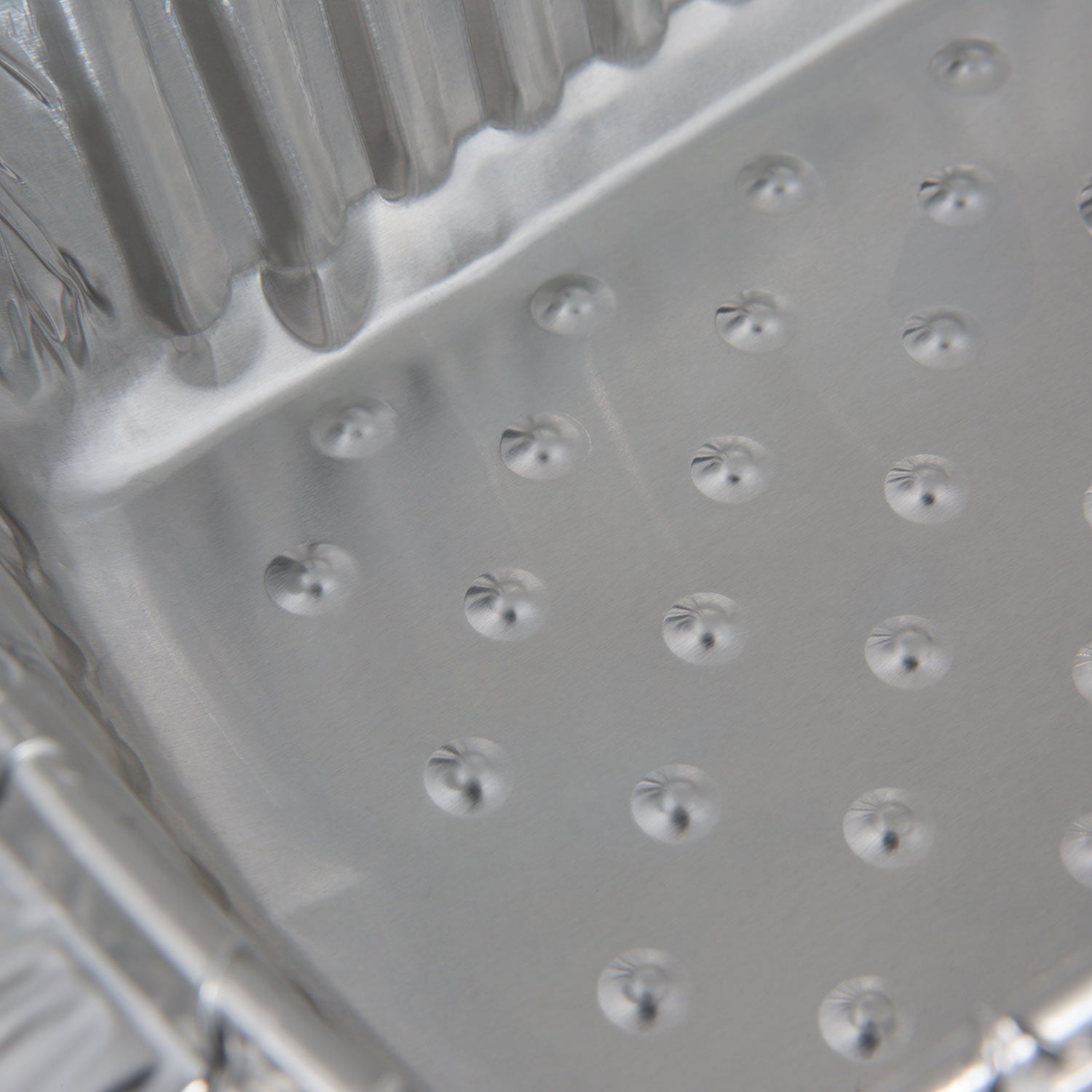 Aluminum foil roaster liner interior with raised dots texture