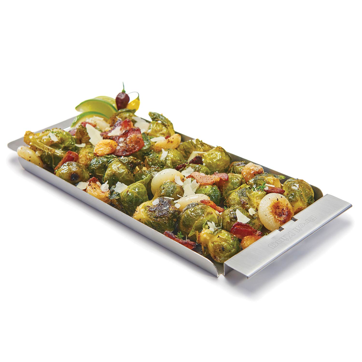 Narrow stainless steel grill topper tray with side handles, holding roasted vegetables