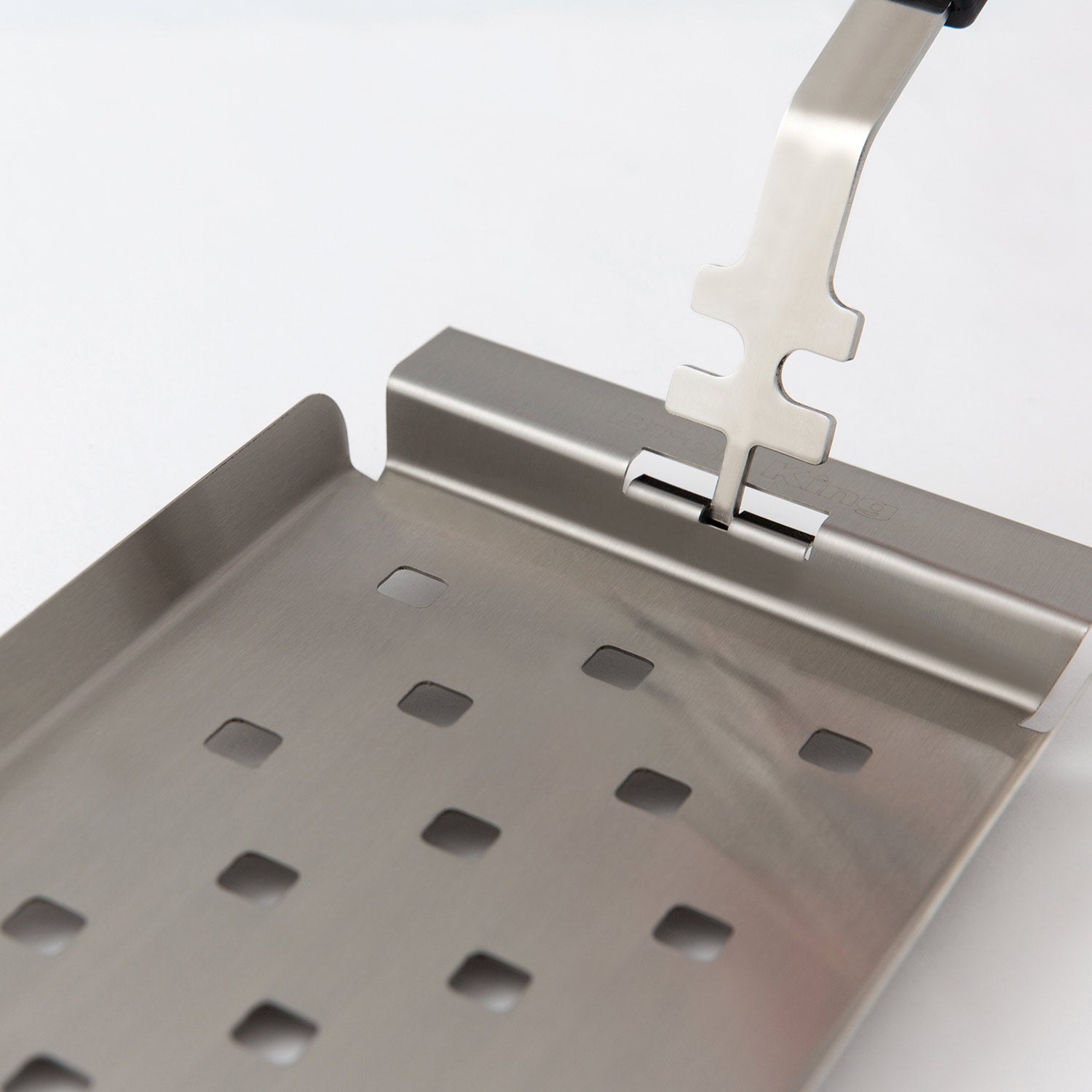 Stainless steel grill topper tray with perforations and front locking bar