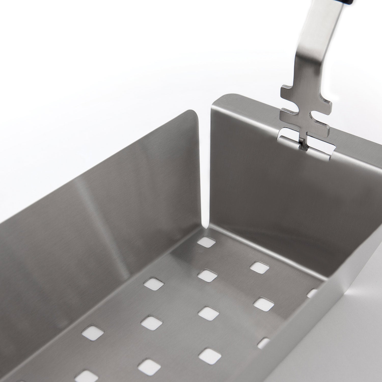 Stainless steel wok grill topper insert with square holes, close-up