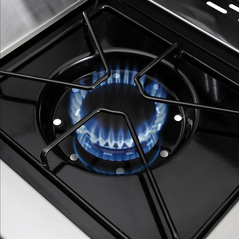 Gas burner with visible blue flames beneath the grill grates
