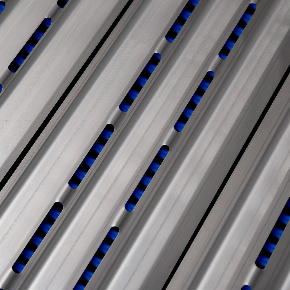Close-up of stainless burner tubes with blue flame slots