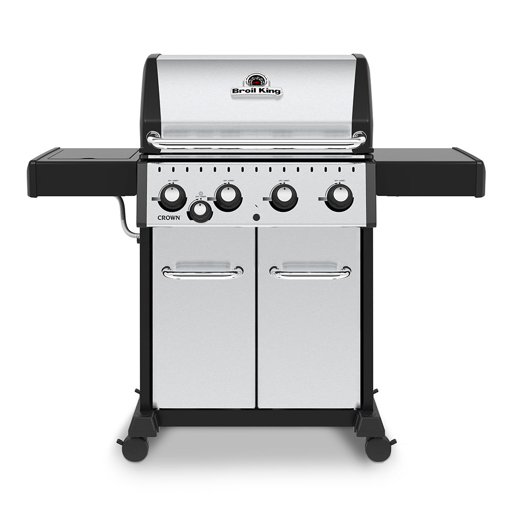 Stainless steel gas grill with side burner and four burner control knobs, closed lid