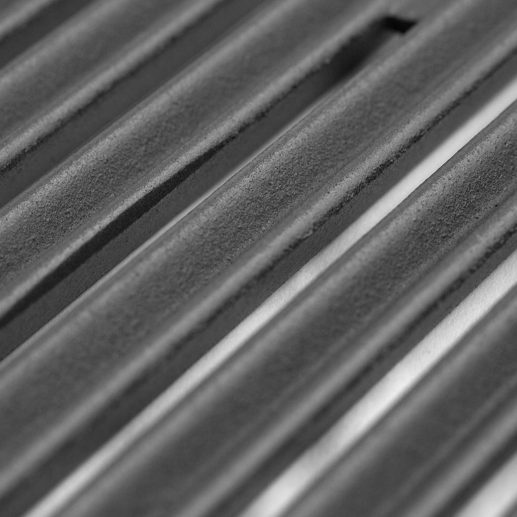 Close-up of gas burner tubes with blue ignition flames