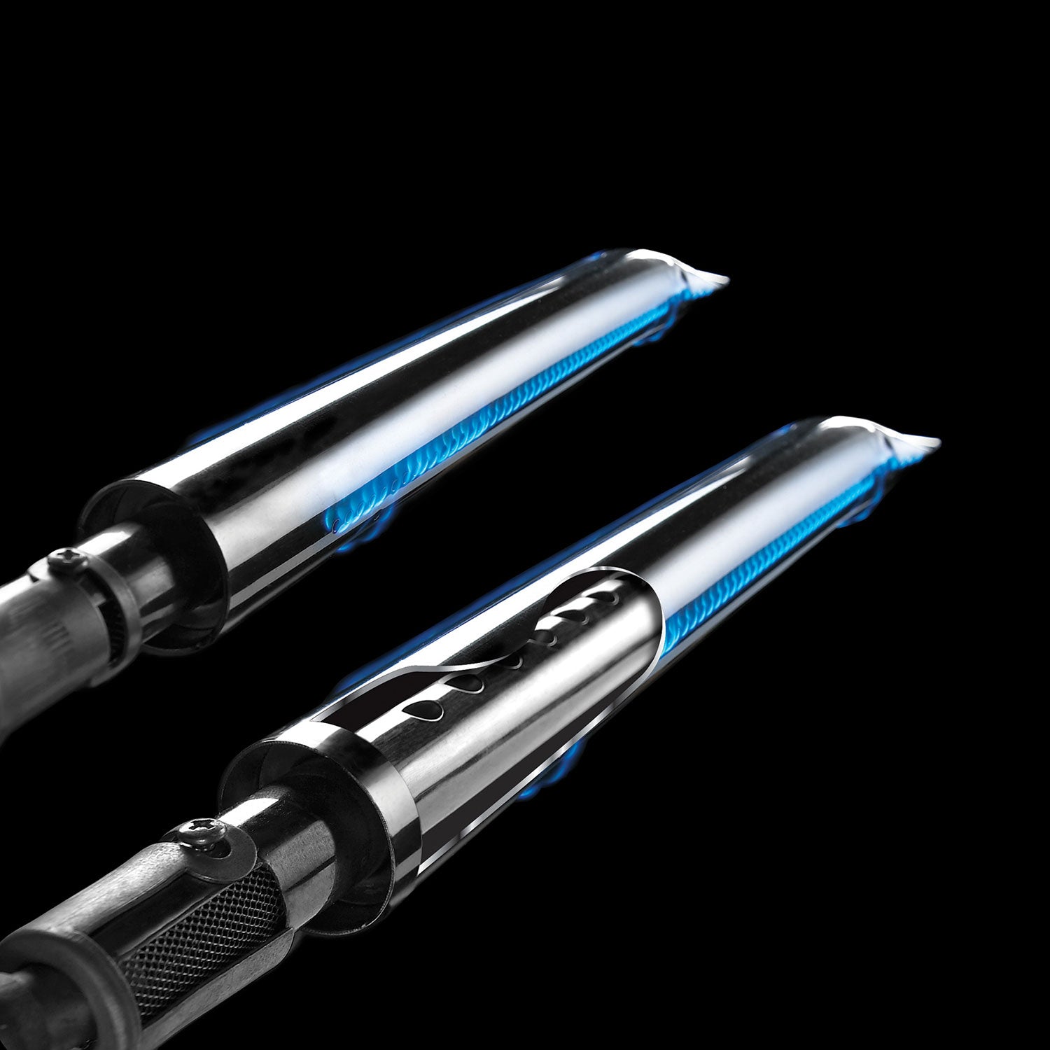 Gas burner tubes with blue ignition flames and black ignition module