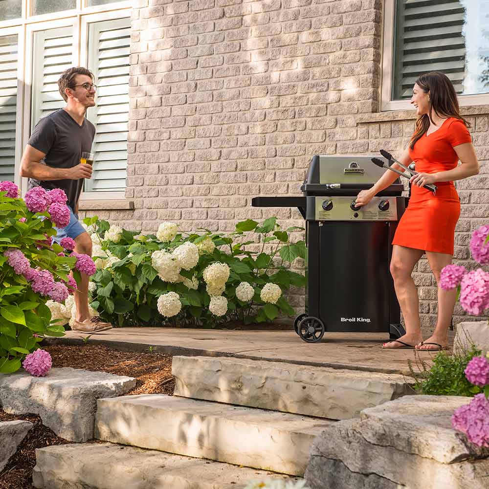 Broil King 3-burner propane grill on 2-wheel cart with lid closed