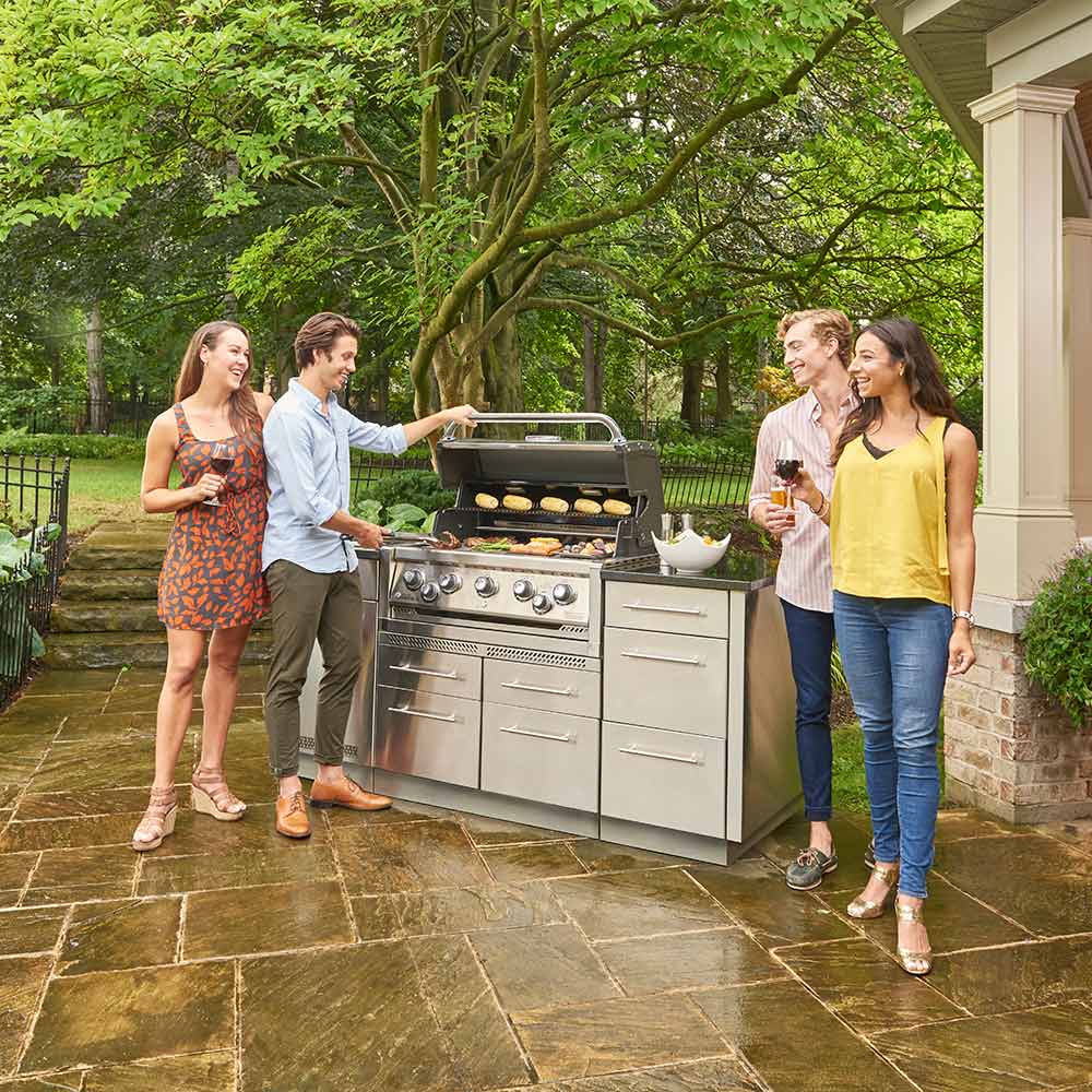 Stainless steel 5-burner gas grill in outdoor patio setting