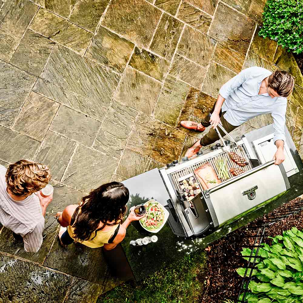 Stainless steel 5-burner gas grill with open lid and cooking grates