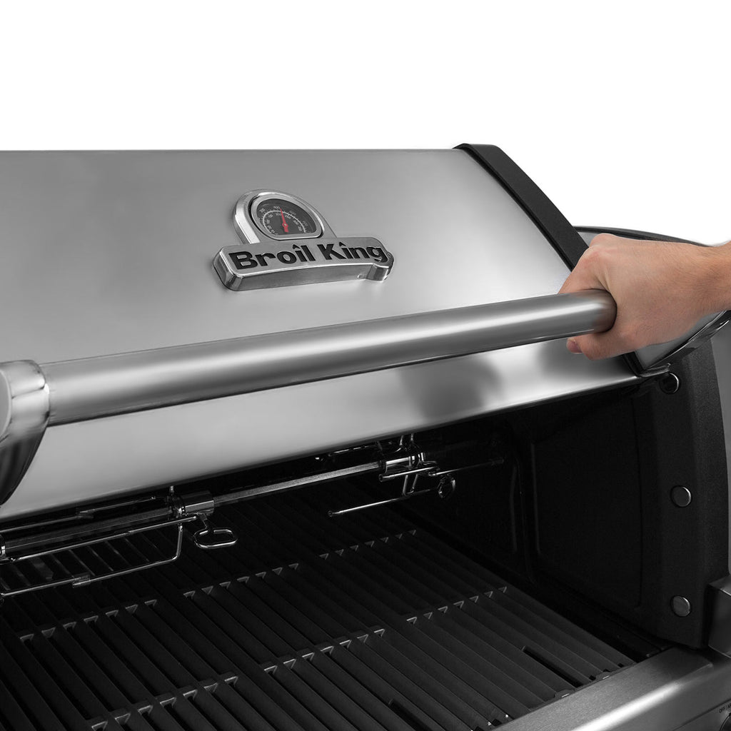Broil King stainless steel grill lid with folding handle over open hood