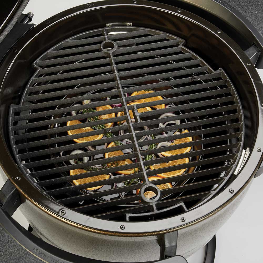Black slotted heat diffuser grate installed inside a keg grill with handles