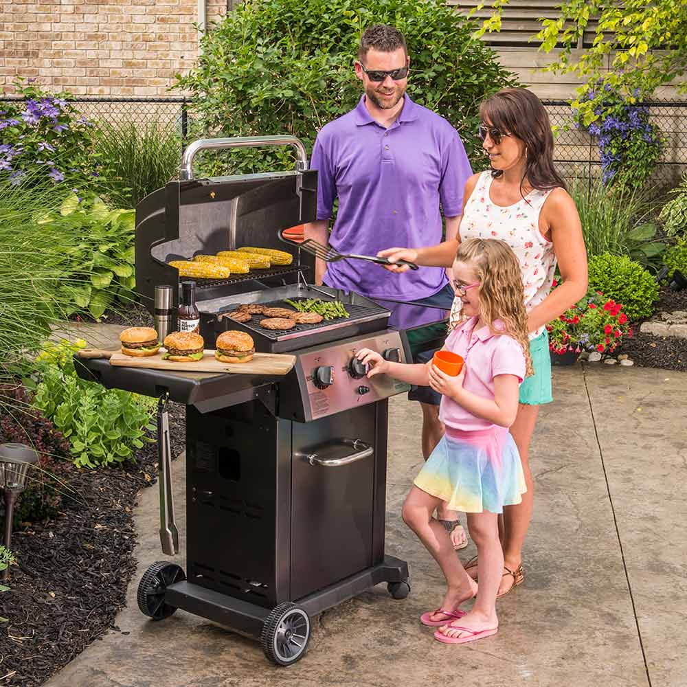 3-burner gas grill on cart with lid open and food grilling on the grate