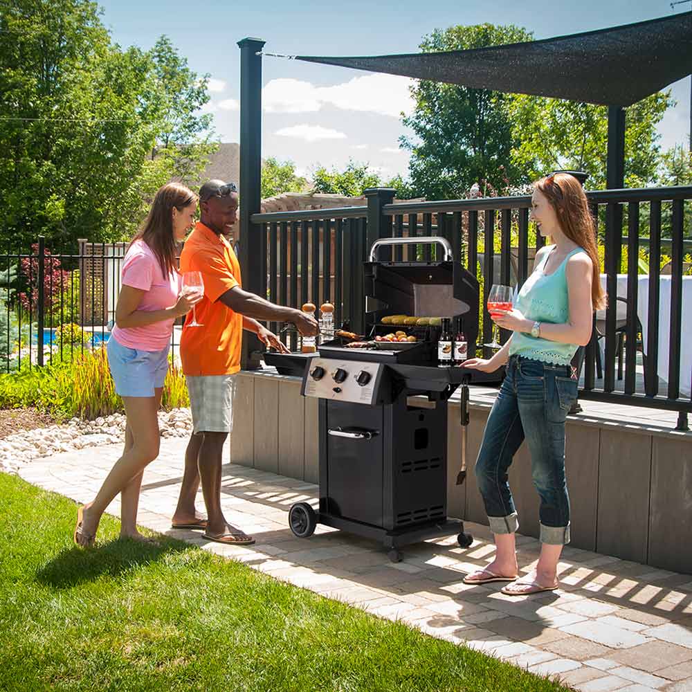 3-burner gas grill on cart with side shelves and control panel in an outdoor patio setting