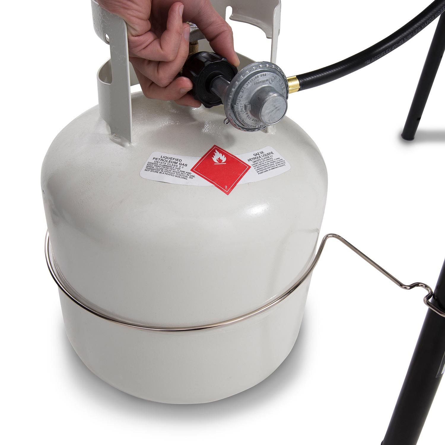 Propane tank regulator with hose connected to a portable propane grill