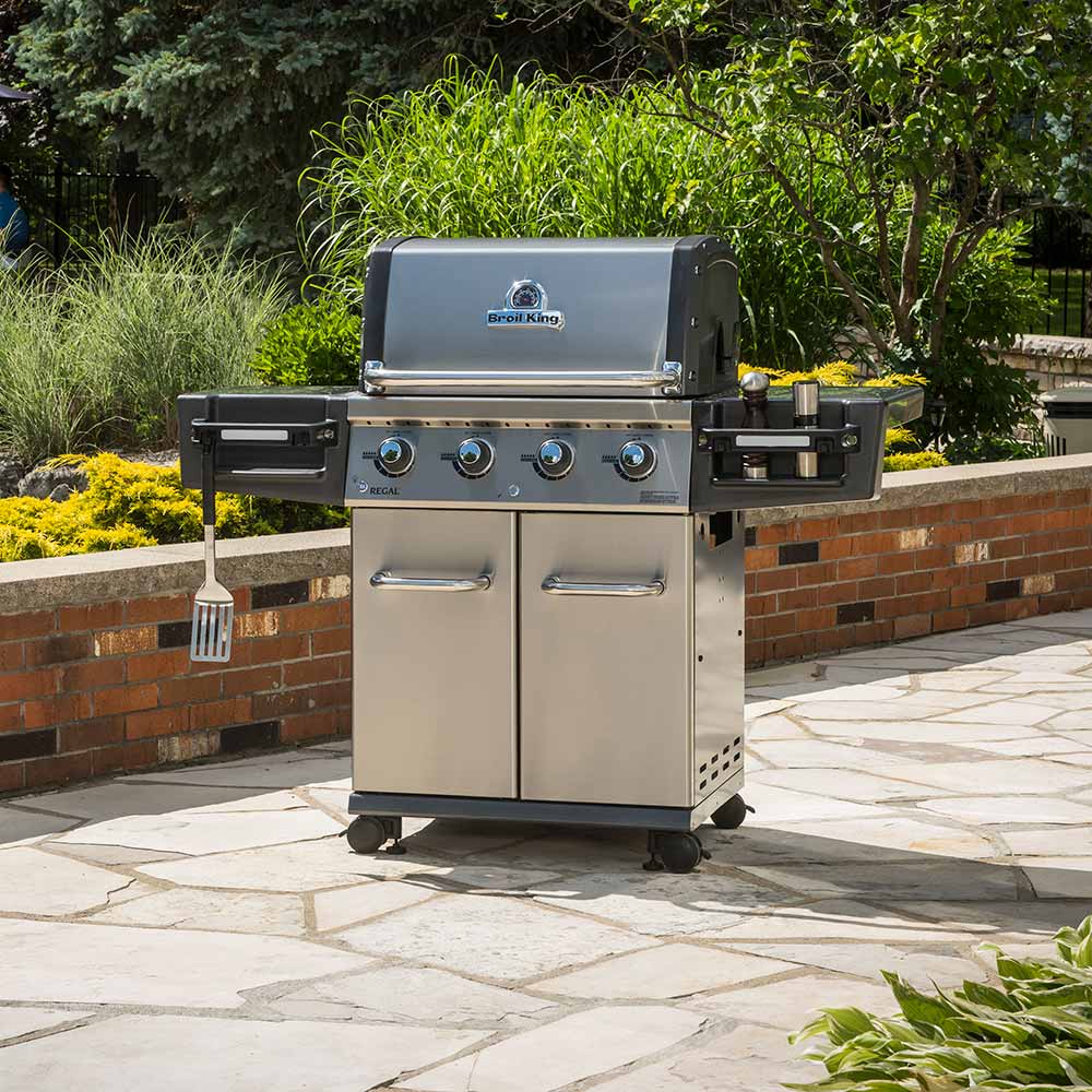 Stainless steel 4-burner gas grill with closed lid and side control panel