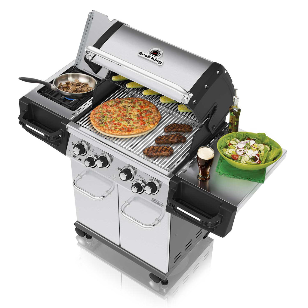 Stainless steel gas grill open with pizza and meat cooking on grates