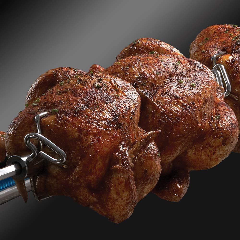 Grilled chicken on rotisserie spit with metal hook handles