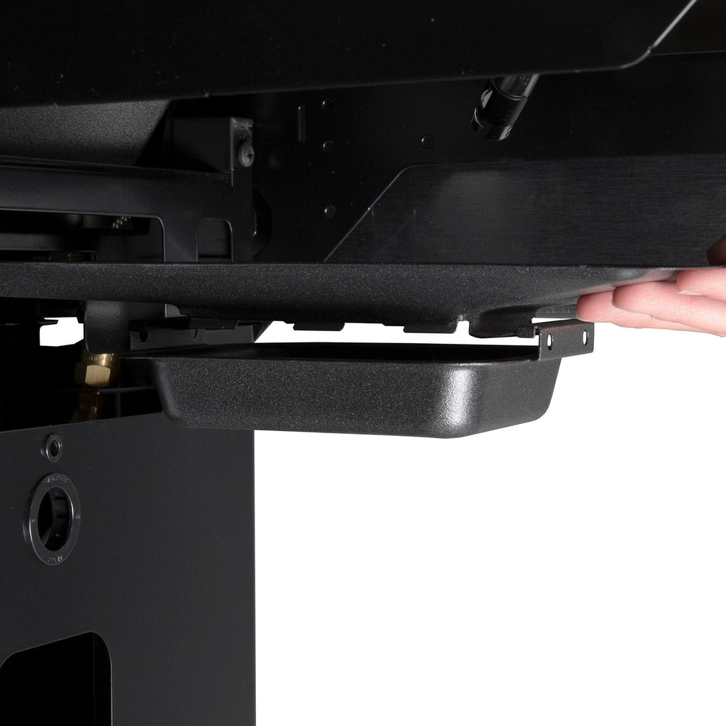 Underside of gas grill with hand reaching a control component