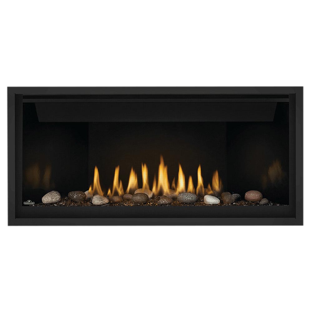 Black gas fireplace with glass front, glowing flames and decorative rocks