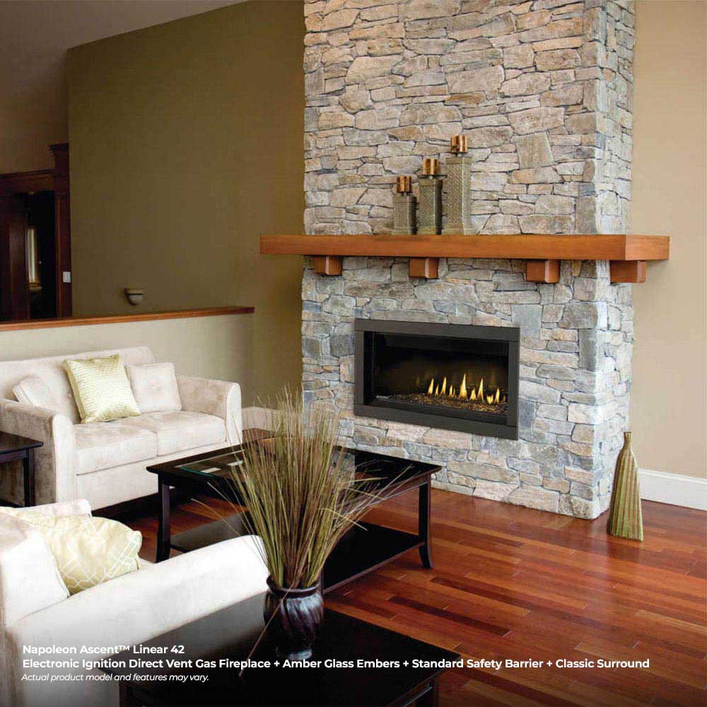 Black linear gas fireplace insert with glowing flames and stone surround in living room