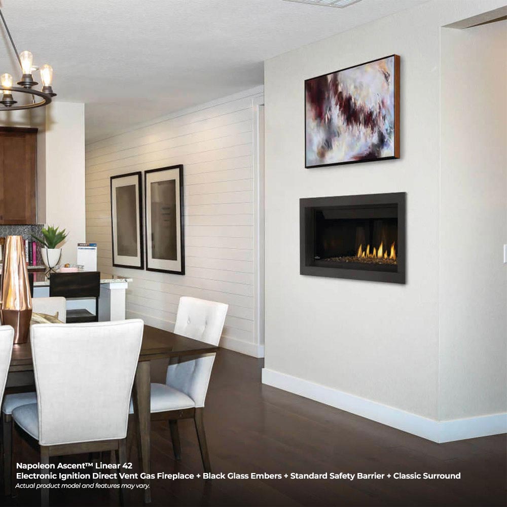 Black gas fireplace insert with ember bed and visible flames in a wall niche
