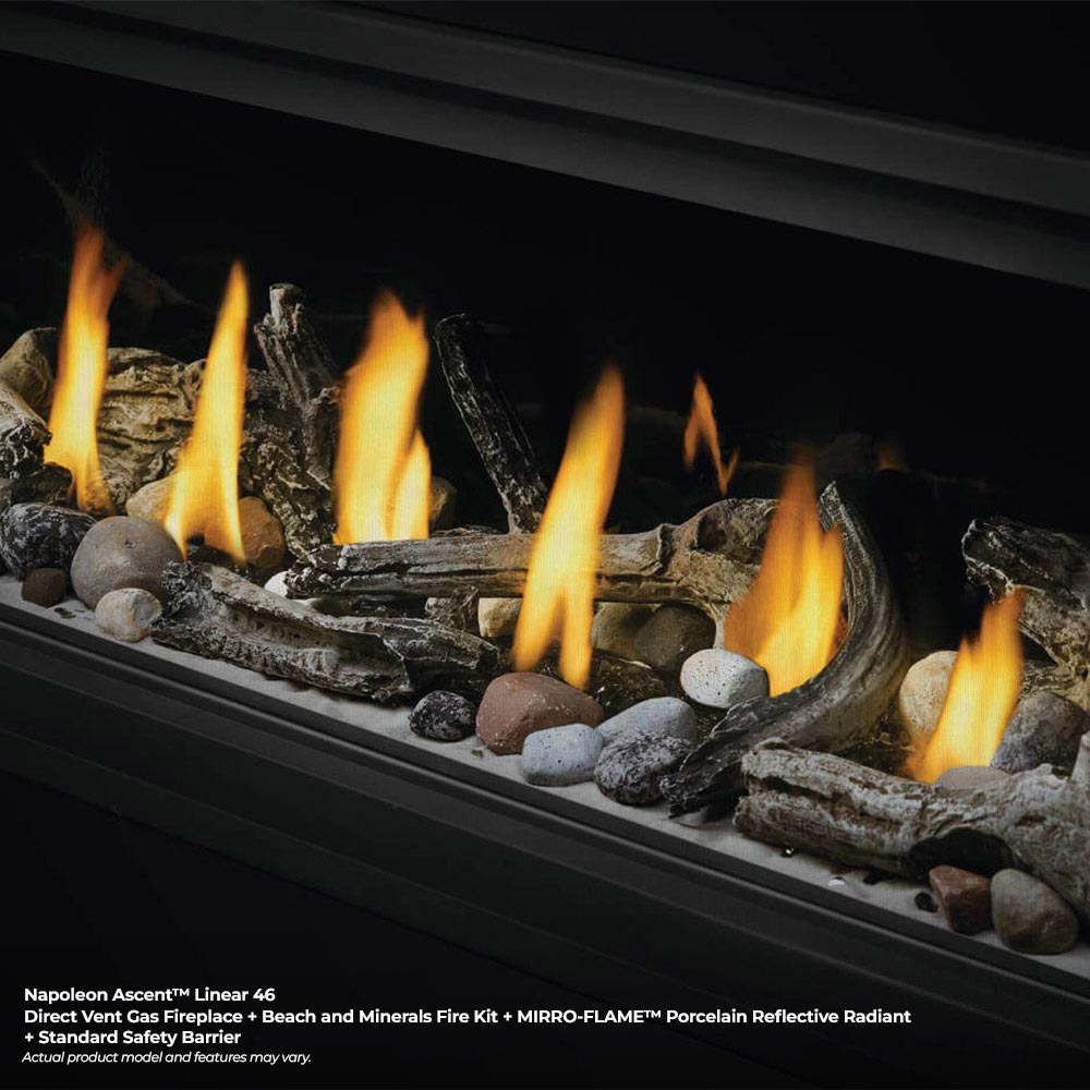 Linear fireplace burner with flames, wood pieces, and gray stones under black frame