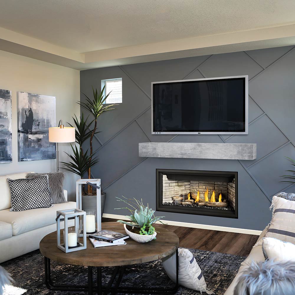 Direct vent gas fireplace with black trim and lit log set inside