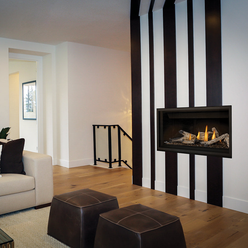 Direct vent gas fireplace with black surround and small flames over log set
