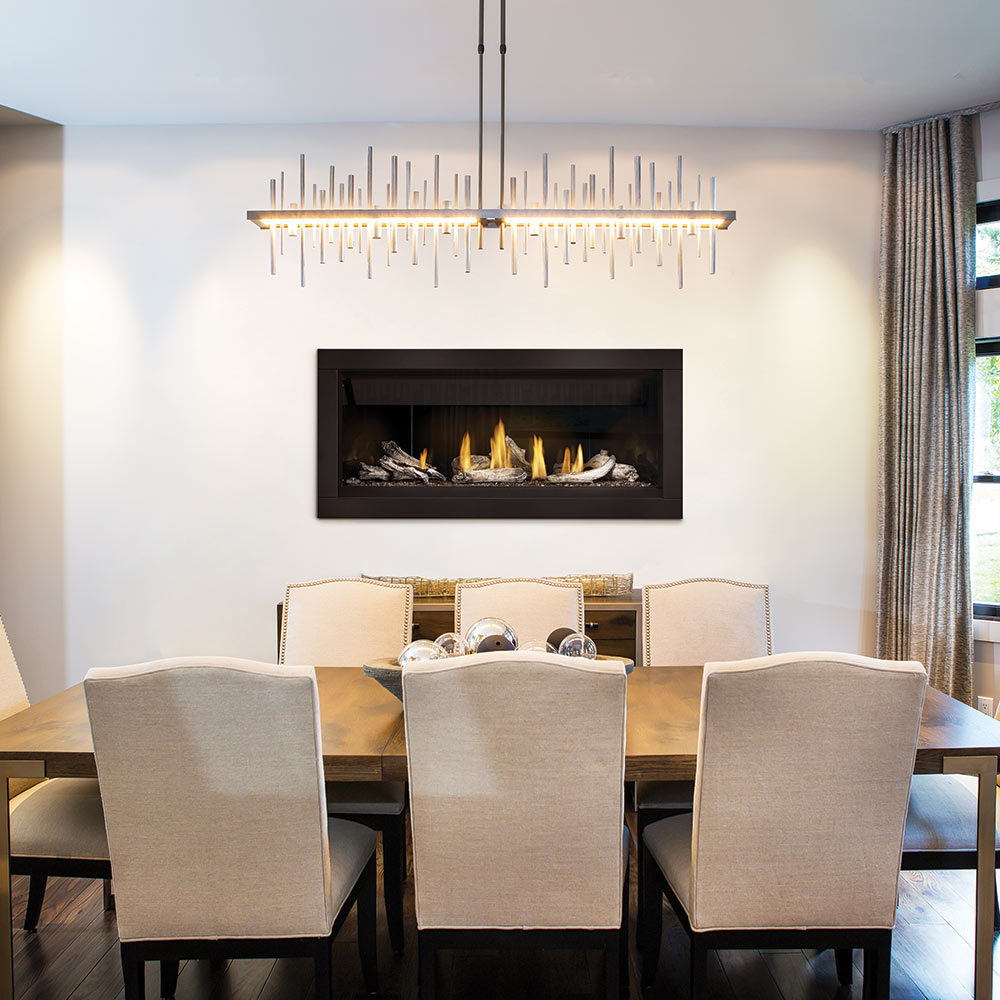 Linear gas fireplace with burning logs and orange flames in a black surround