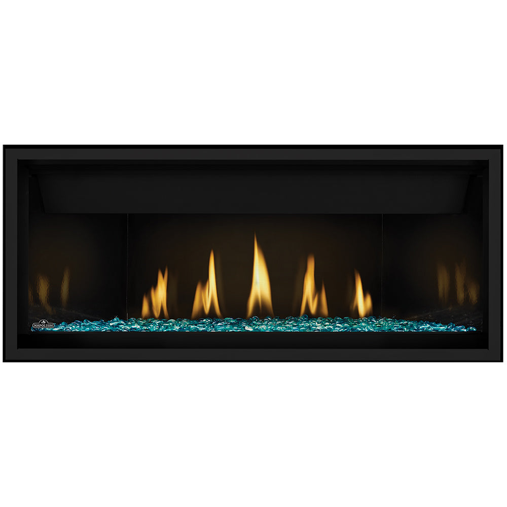 Direct vent gas fireplace with blue-green glass embers and black surround; flames visible