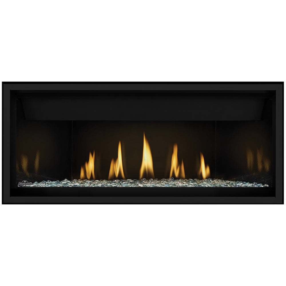 Direct vent gas fireplace with white glass embers and black surround; flames visible