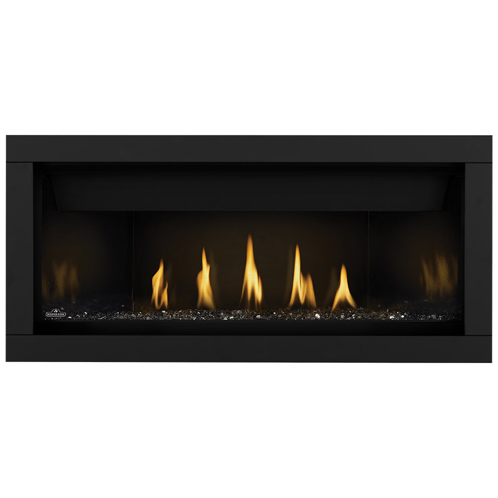 Linear gas fireplace with burning flames over dark ember bed in a black frame