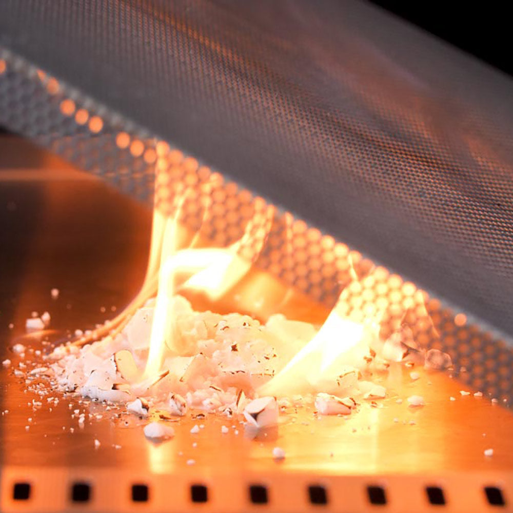 Flame barrier over a grill burner, glowing orange flame through perforated mesh