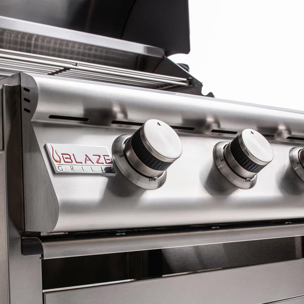 Gas grill control panel with three burner knobs and Blaze brand label