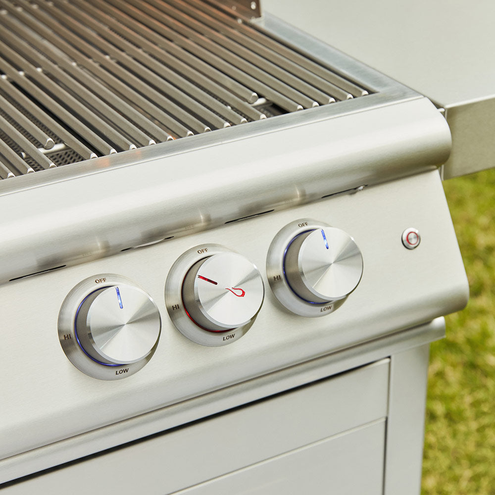 Gas grill front control knobs and stainless side rails, grill grate visible.
