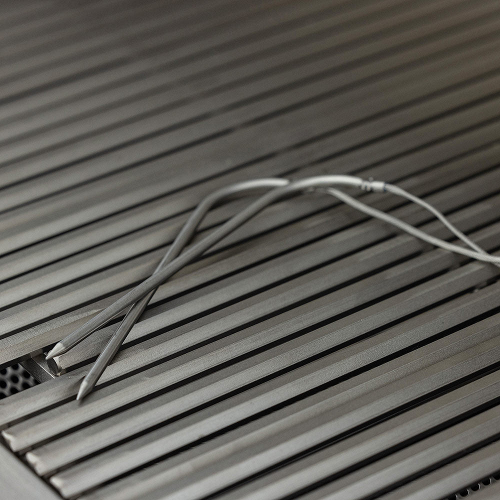 Stainless steel grill grates with igniter wires along the burner bed