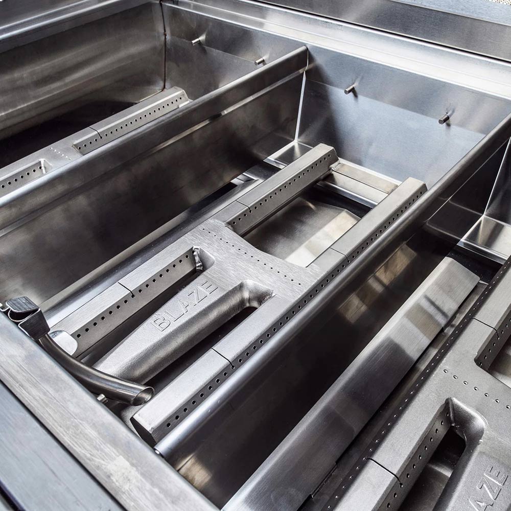 Stainless grill burner system with vented heat plates inside the firebox