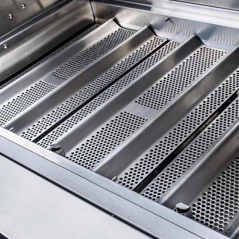 Vented stainless heat plates with rows of perforations inside the grill firebox