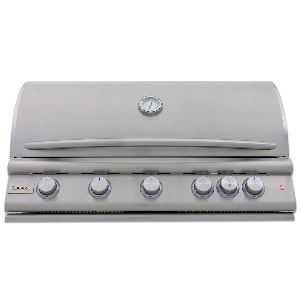 Built-in stainless gas grill with hood, temperature gauge, and front control knobs.