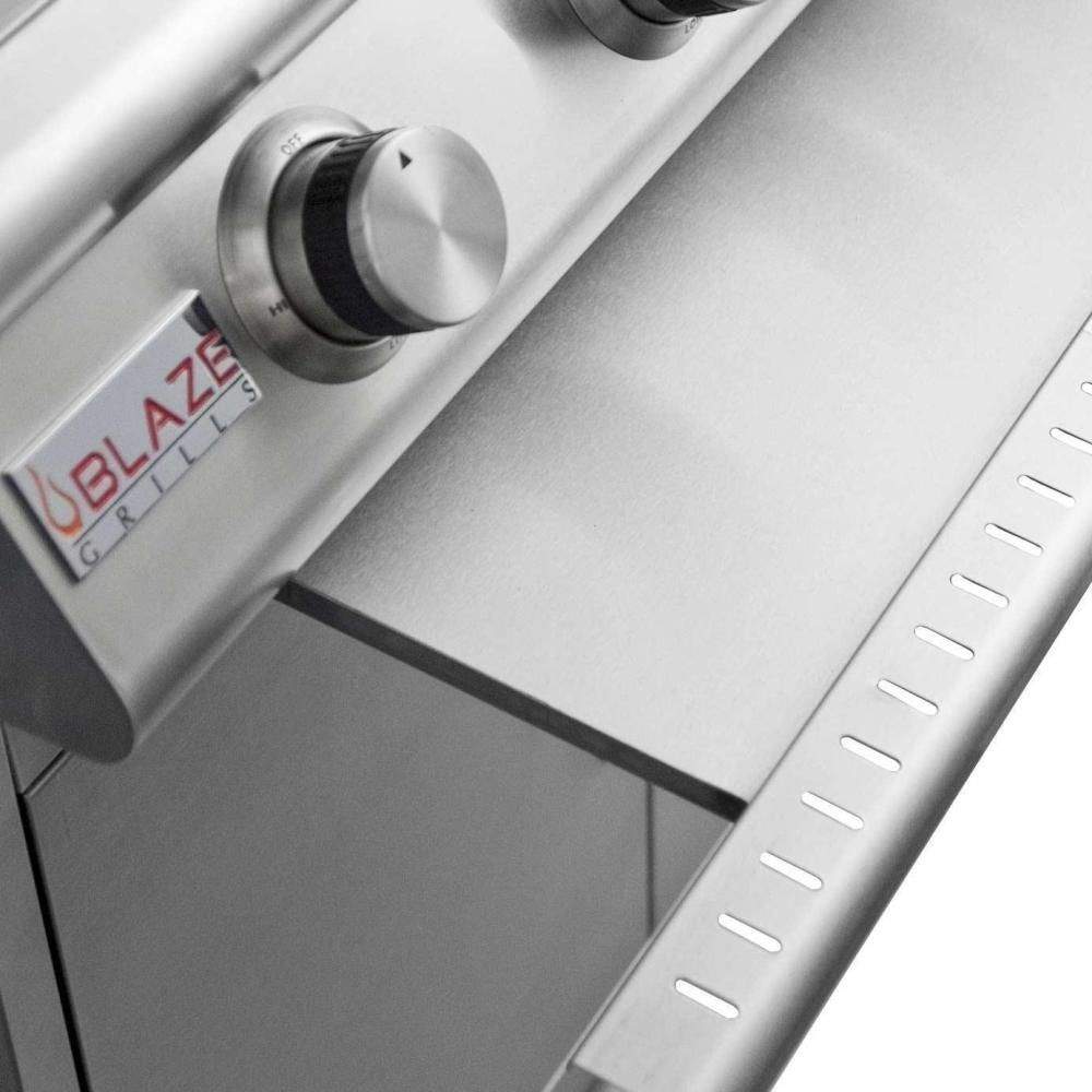 Built-in gas grill side control panel with Blaze knob and smooth stainless surface