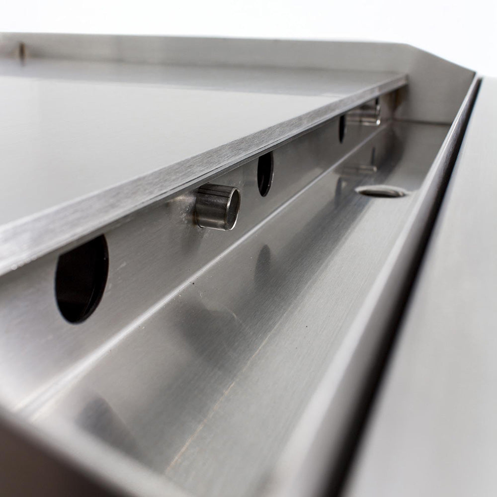 Stainless steel drip tray area with vent holes and front cutout handles