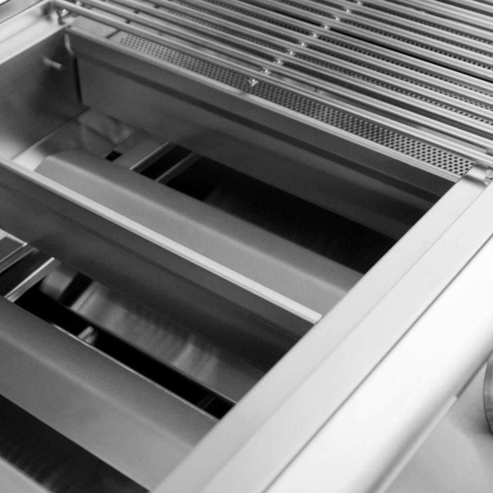 Close-up of grill firebox with stacked heat plates and side rails